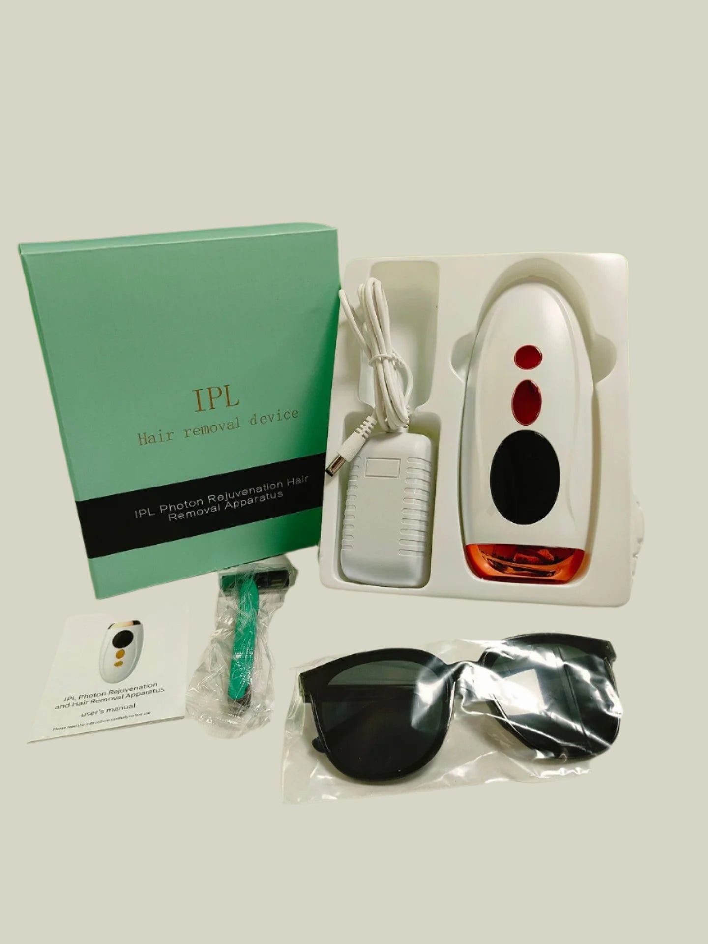 IPL hair removal device with accessories on a white surface